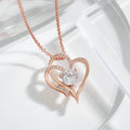 Rose gold double heart pendant close up, the centre solitaire catching the light