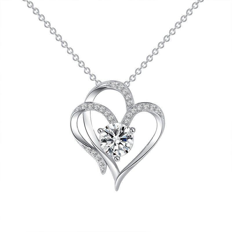 Silver double heart pendant with pave stones along one heart and a round solitaire at the centre, on a fine cable chain